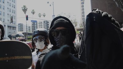 A photo of masked and goggled antifa agents