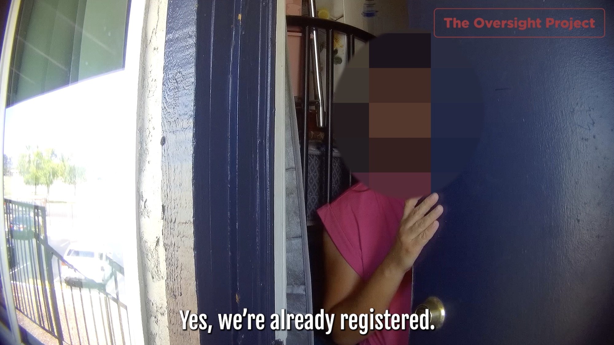 A suspected non-citizen with their face blurred out opening the door