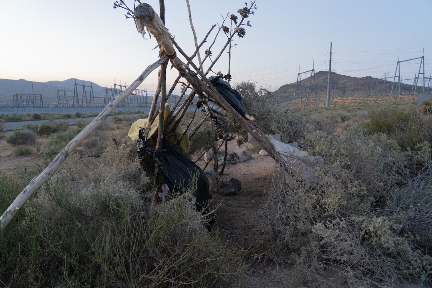 A teepee made of sticks outside of a Southern California substation