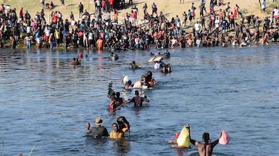 A photo of Haitian illegal aliens crossing the Rio Grande into Texas