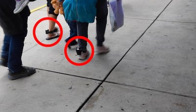 A photo of the ankles of illegal aliens wearing tracking devices