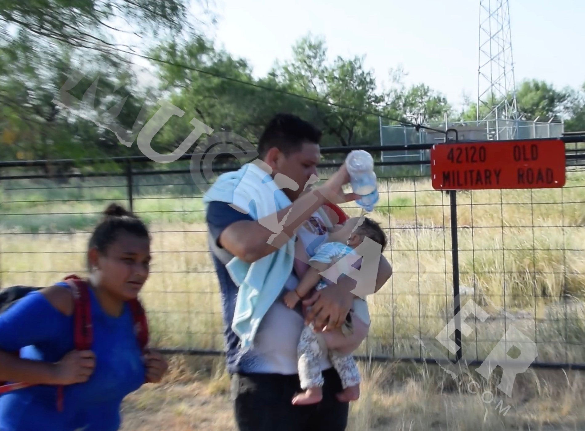 An illegal alien who just crossed into America holding a baby