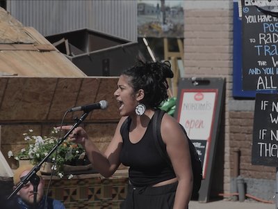 A photo of a woman screaming at George Floyd Square