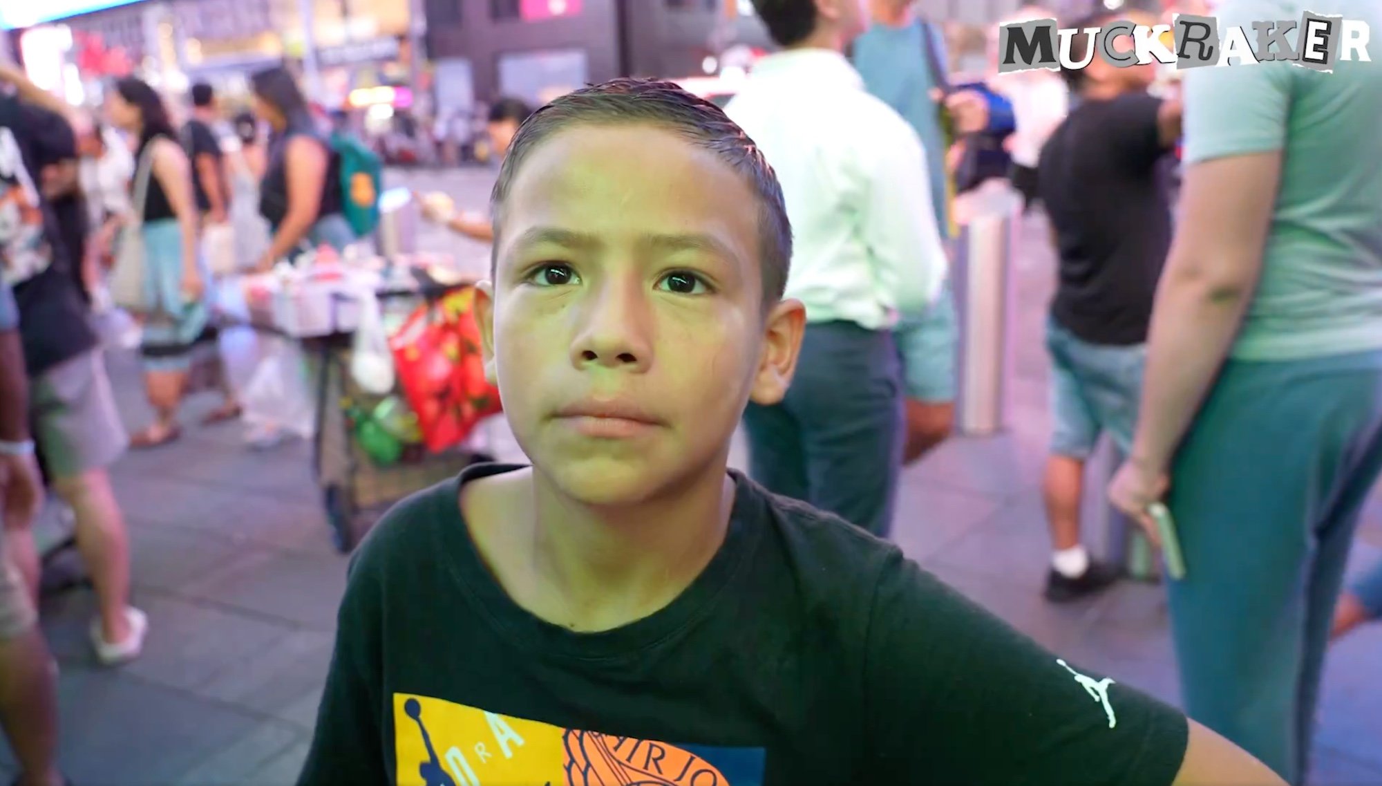 A young boy working in Times Square