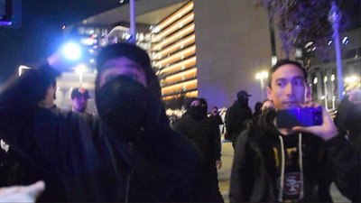 A photo of a crazed antifa agent holding a flashlight