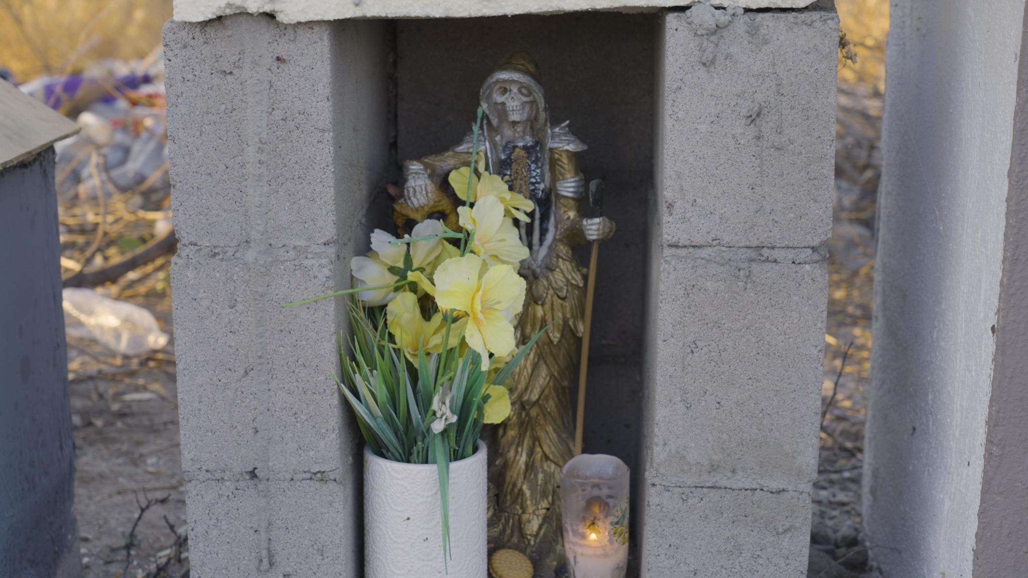 A Santa Muerte shrine with flowers