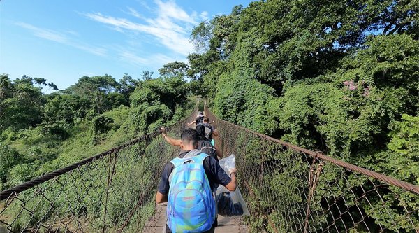 Crossing a bridge with other illegal aliens in cartel controlled territory in Southern Mexico