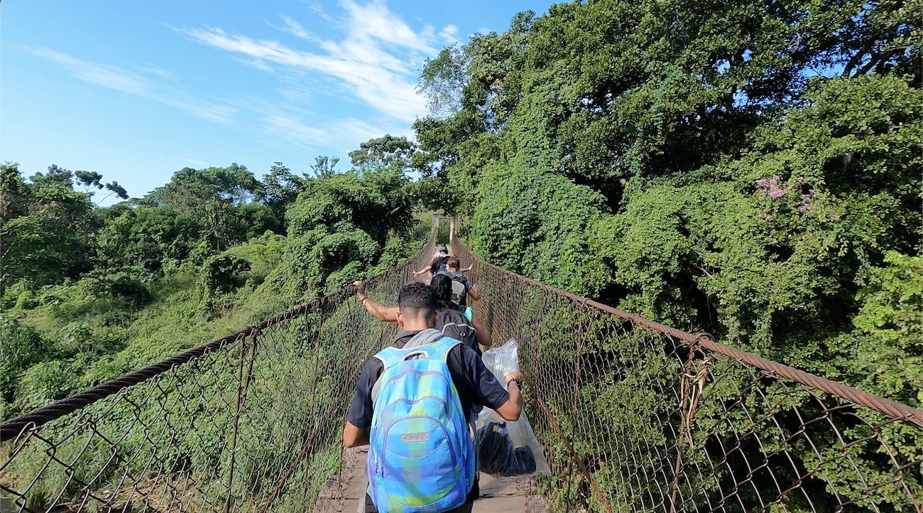 Crossing a bridge with other illegal aliens in cartel controlled territory in Southern Mexico